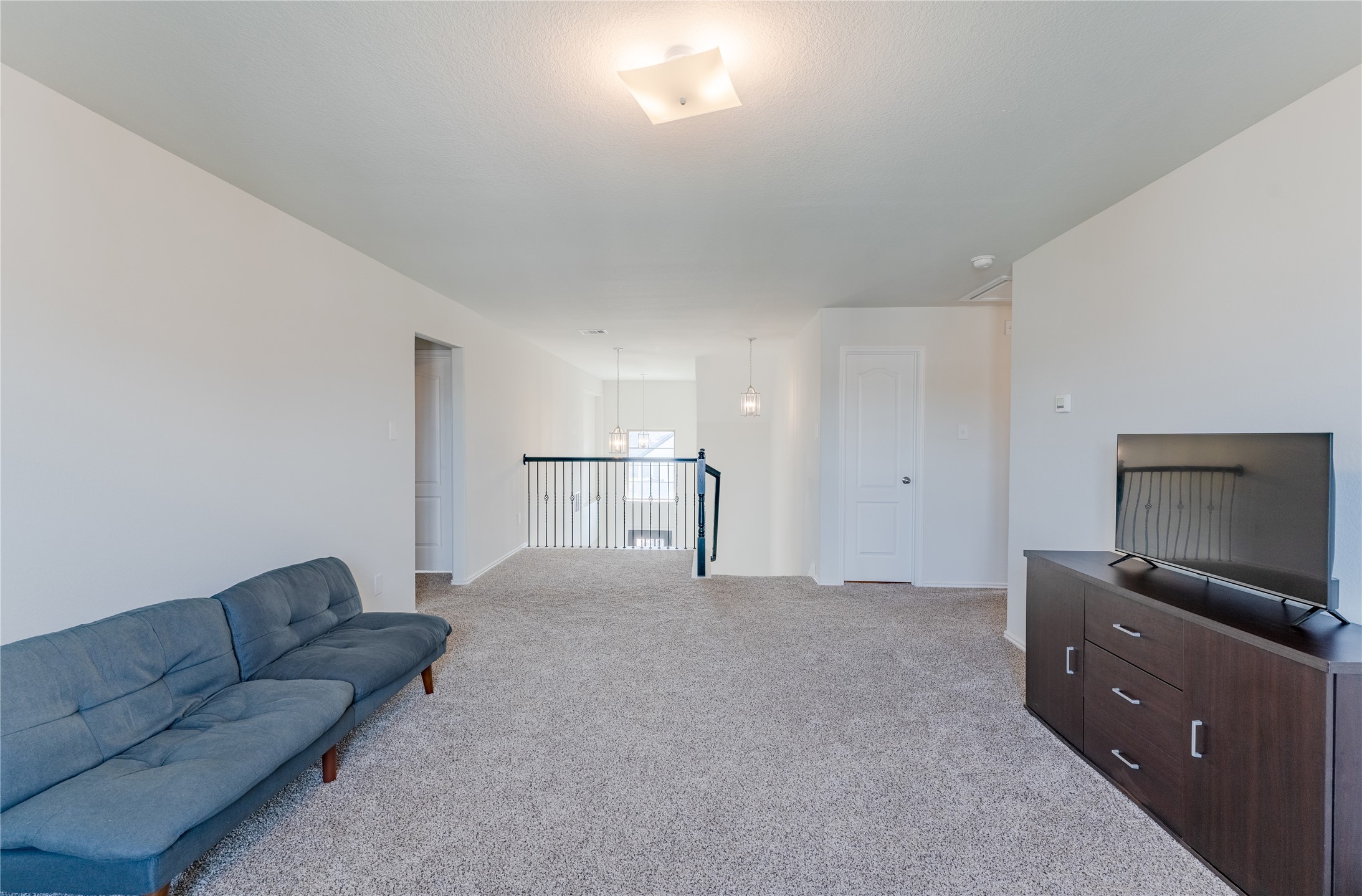 8327 Threadfin Way Fulshear, TX 77441 - Photo 15 of 40 a living room with furniture and a flat screen tv