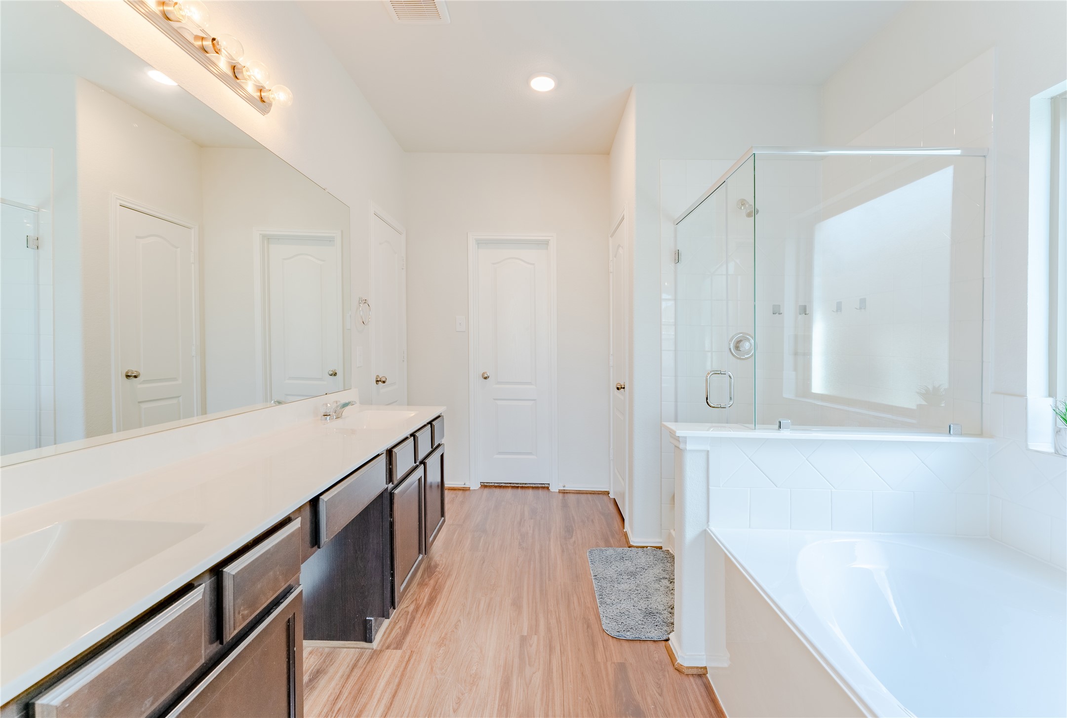 8327 Threadfin Way Fulshear, TX 77441 - Photo 17 of 40 a bathroom with a sink a bathtub and a shower