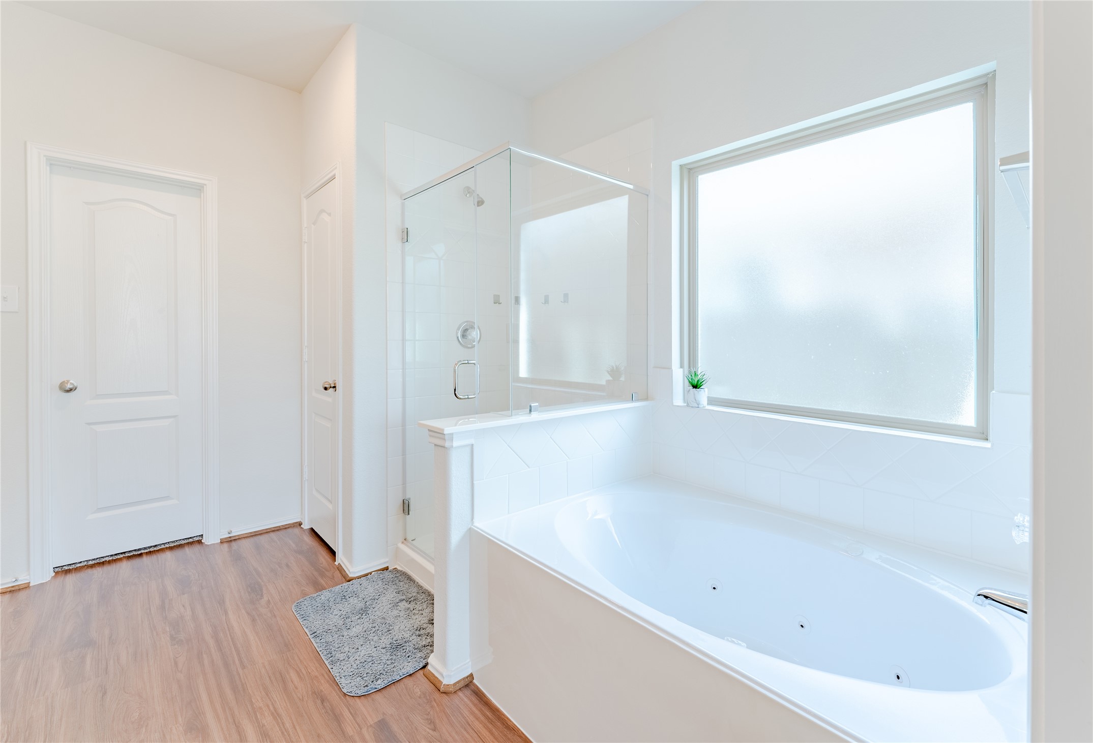 8327 Threadfin Way Fulshear, TX 77441 - Photo 19 of 40 a bathroom with a bathtub and a shower