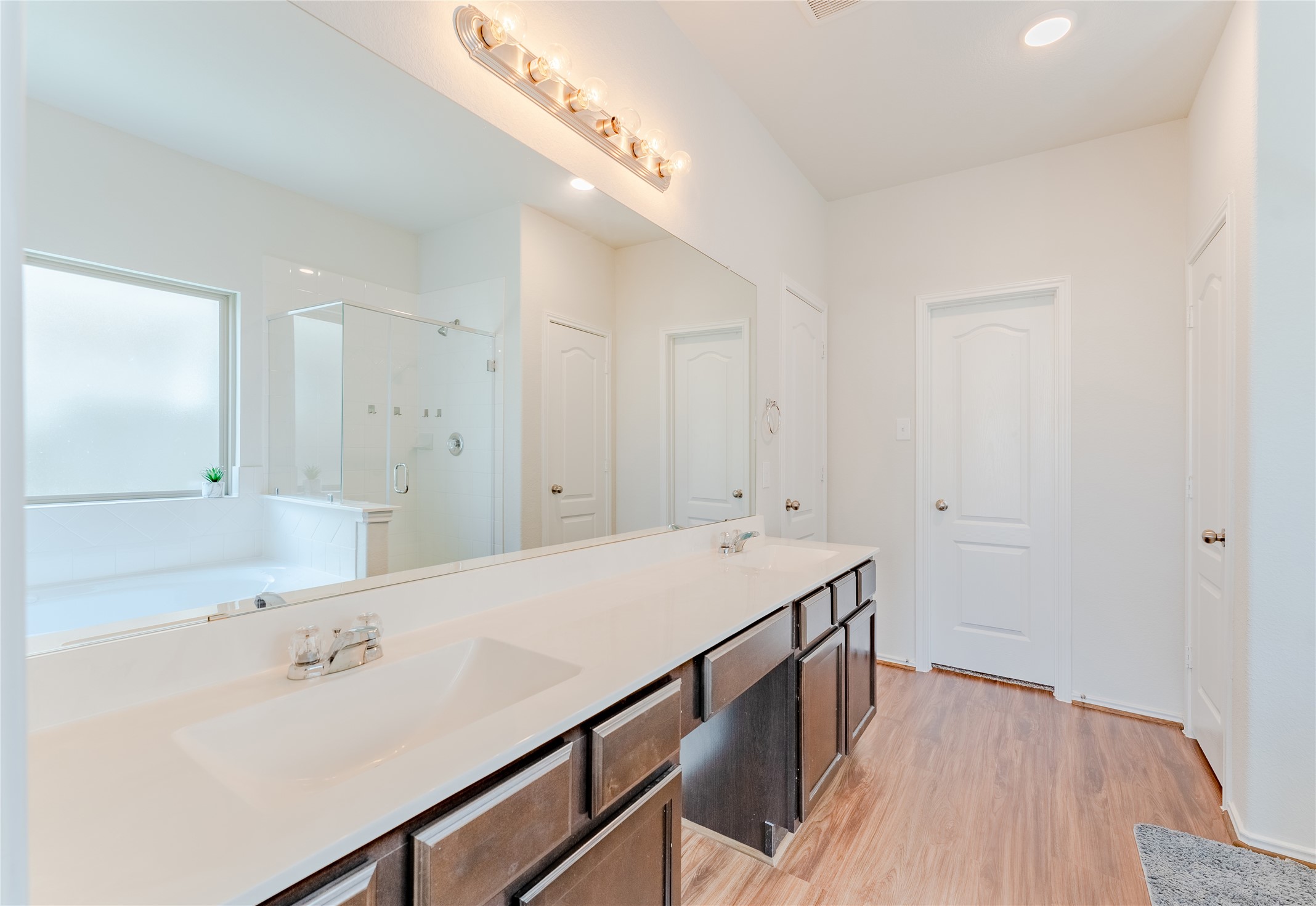 8327 Threadfin Way Fulshear, TX 77441 - Photo 20 of 40 a bathroom with a sink a shower and a mirror