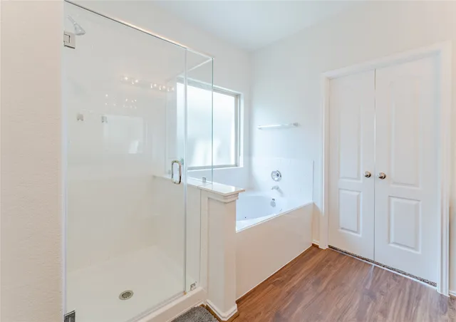 a bathroom with a bathtub and a shower