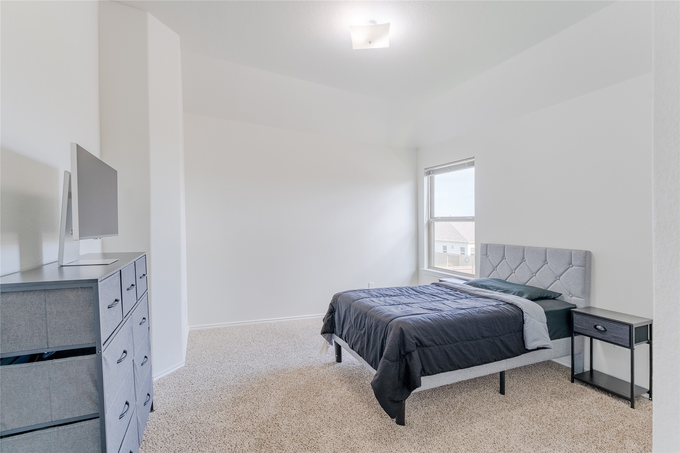 8327 Threadfin Way Fulshear, TX 77441 - Photo 24 of 40 a bedroom with a bed and a fireplace