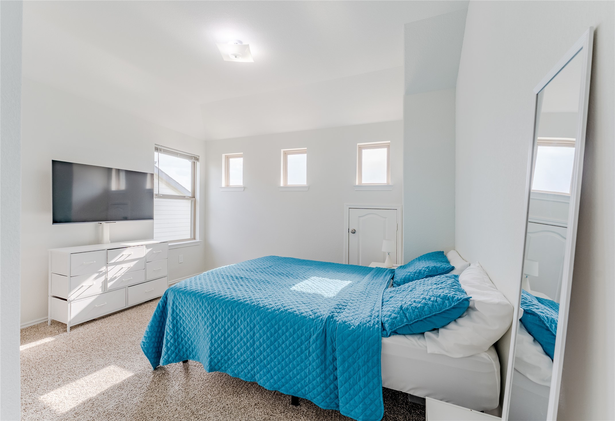 8327 Threadfin Way Fulshear, TX 77441 - Photo 25 of 40 a bedroom with a bed and a flat screen tv