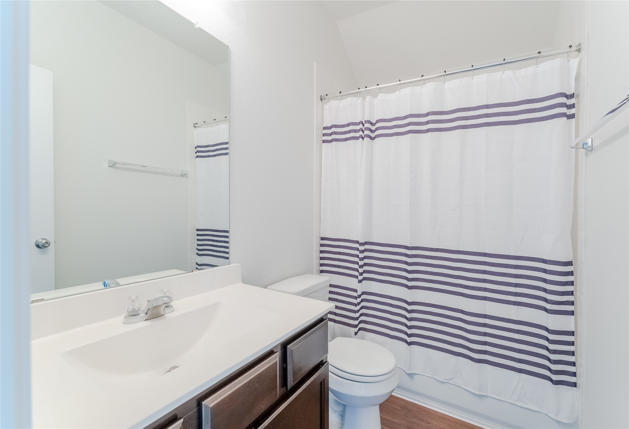 8327 Threadfin Way Fulshear, TX 77441 - Photo 26 of 40 a bathroom with a sink a toilet and shower curtain