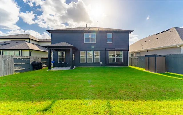 a view of a house with a backyard
