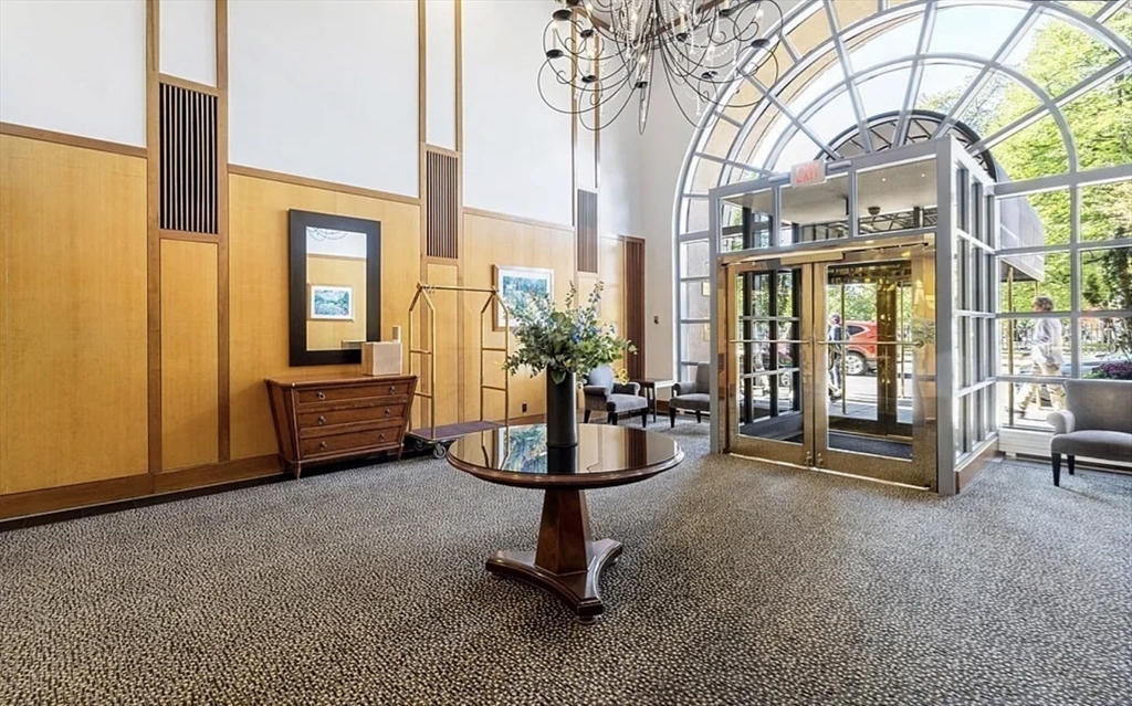 170 Tremont Street, Unit 905 Boston, MA 02111 - Photo 11 of 14 a living room with couches a fireplace and a large window with outer view