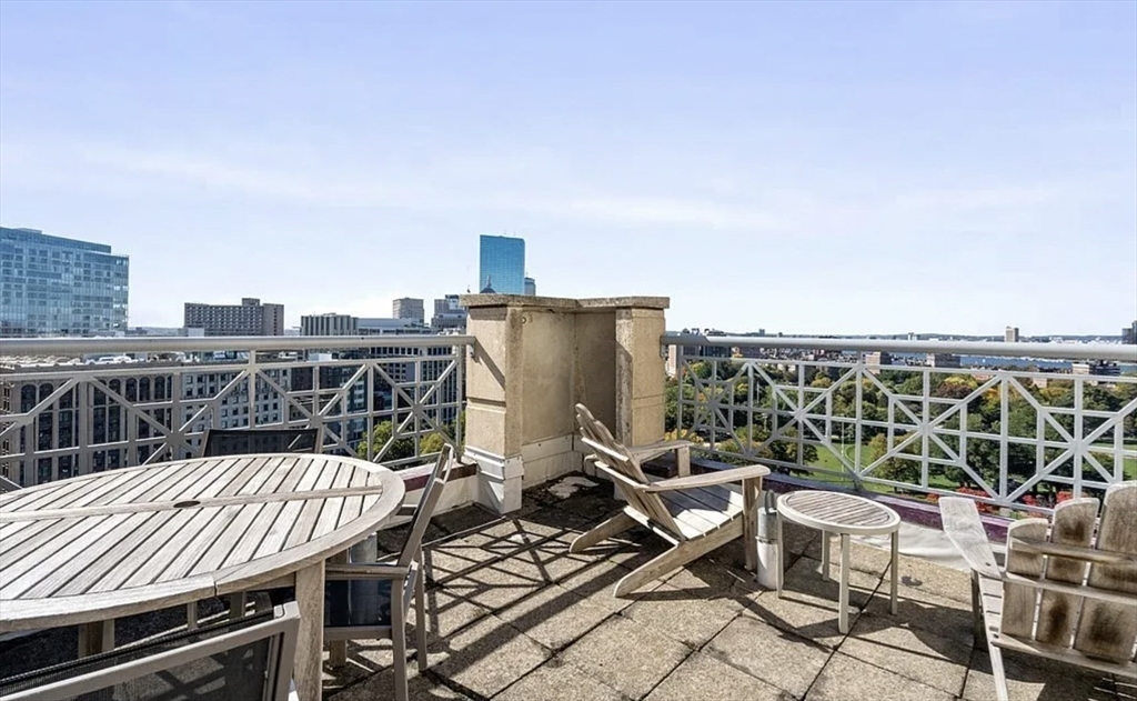 170 Tremont Street, Unit 905 Boston, MA 02111 - Photo 13 of 14 a view of a balcony with two chairs and a table