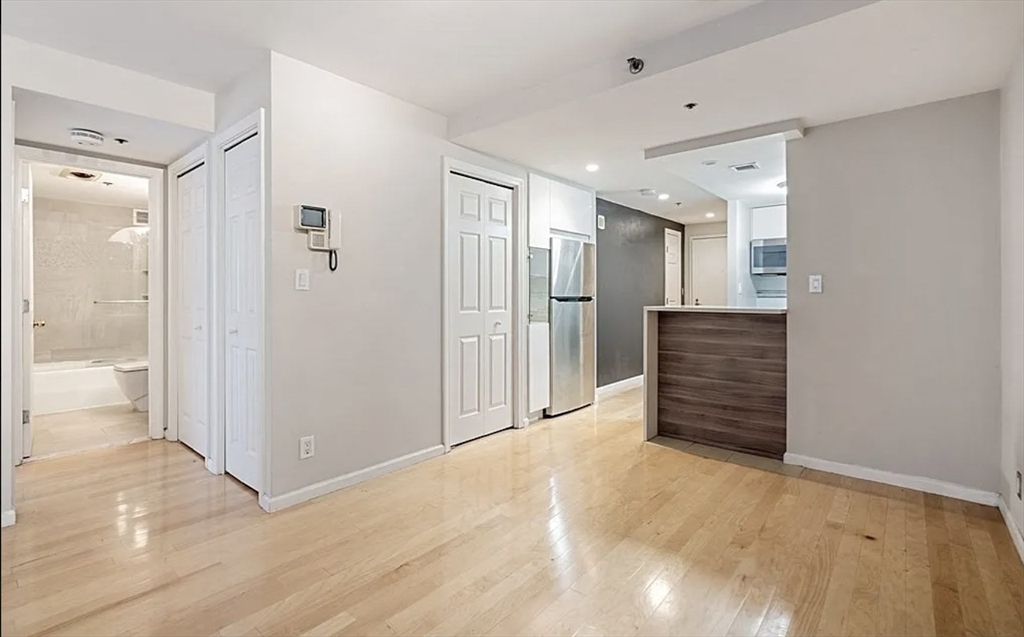 170 Tremont Street, Unit 905 Boston, MA 02111 - Photo 2 of 14 a view of a hallway with wooden shelves