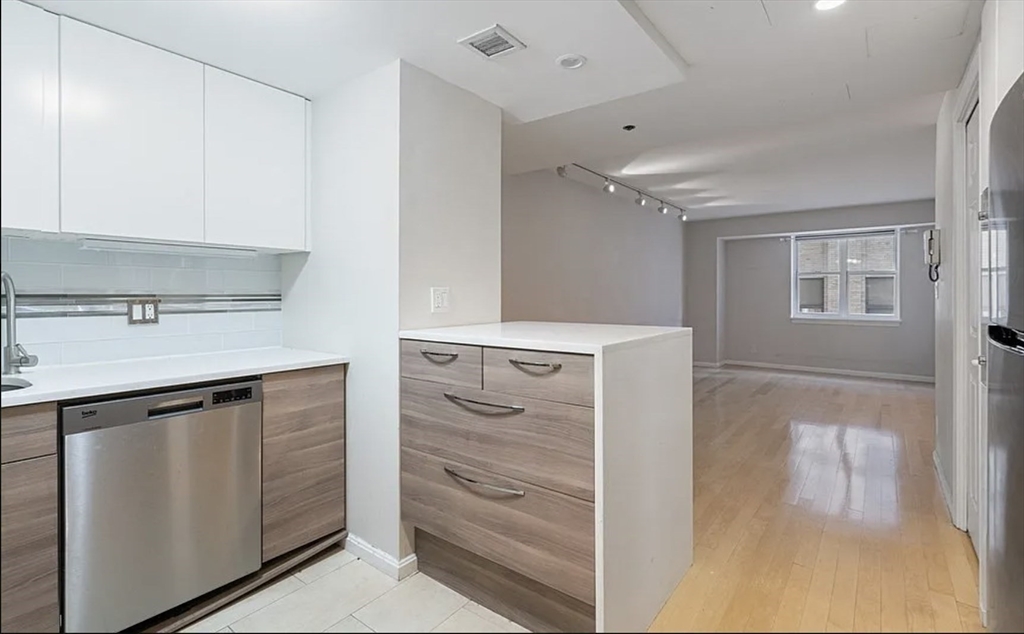 170 Tremont Street, Unit 905 Boston, MA 02111 - Photo 3 of 14 a kitchen with a refrigerator and a sink