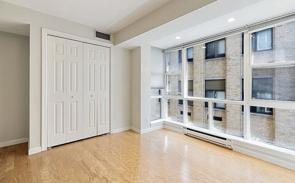 170 Tremont Street, Unit 905 Boston, MA 02111 - Photo 8 of 14 a view of livingroom with furniture wooden floor and window
