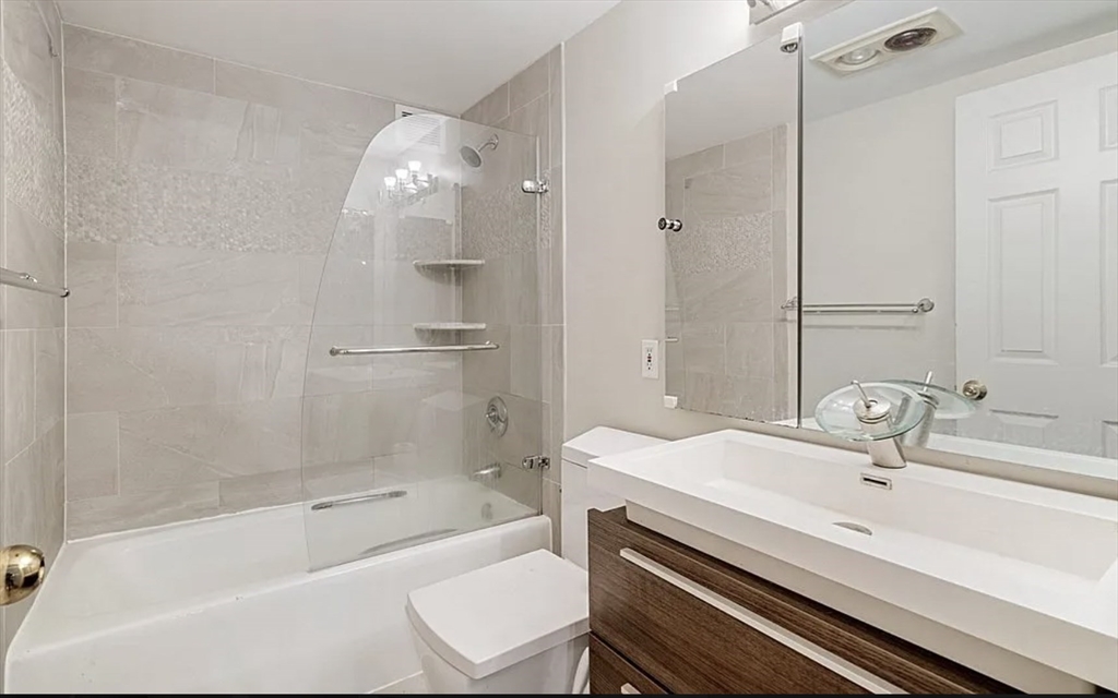 170 Tremont Street, Unit 905 Boston, MA 02111 - Photo 10 of 14 a bathroom with a sink a toilet and shower