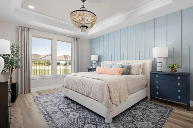 a bedroom with bed and wooden floor