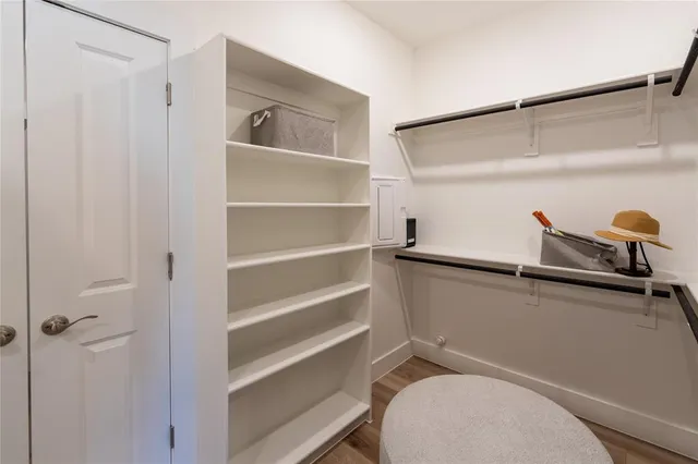 a bedroom with a bed and a large mirror