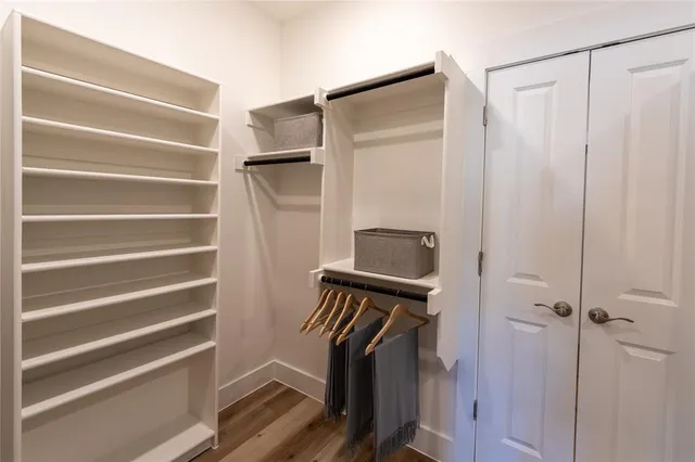 a bathroom with a granite countertop sink a toilet and shower