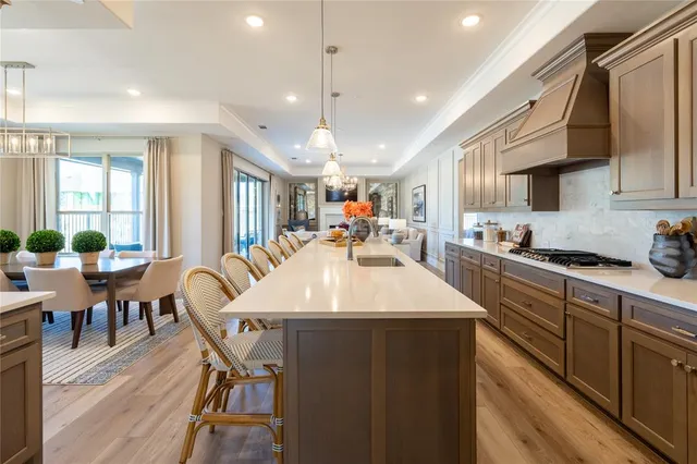 a large kitchen with a table and chairs
