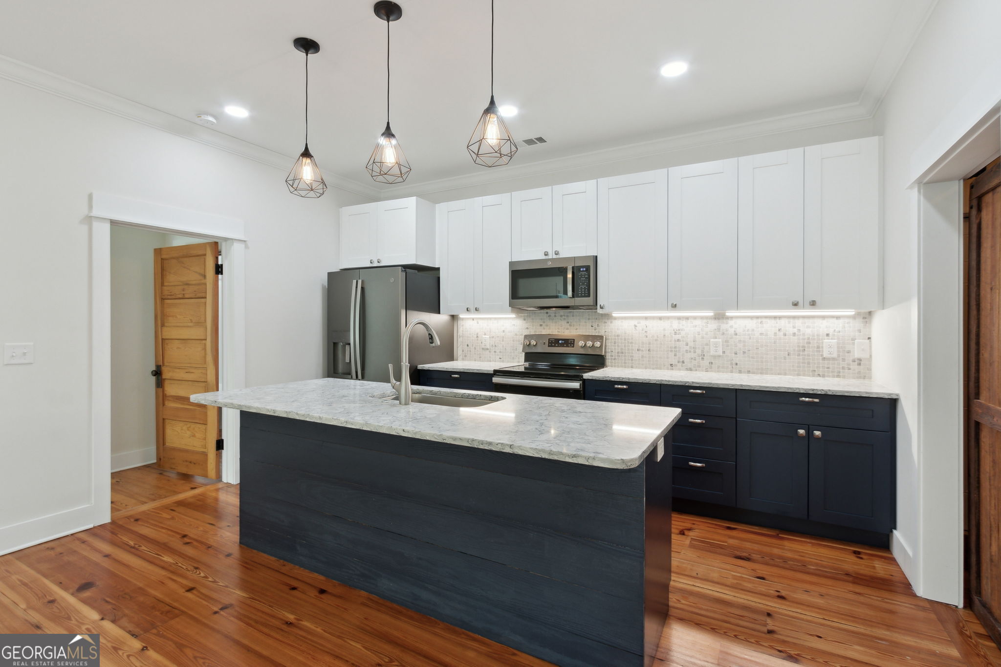 711 Wheeler Street St. Marys, GA 31558 - Photo 16 of 93 a kitchen with kitchen island granite countertop a sink window and refrigerator