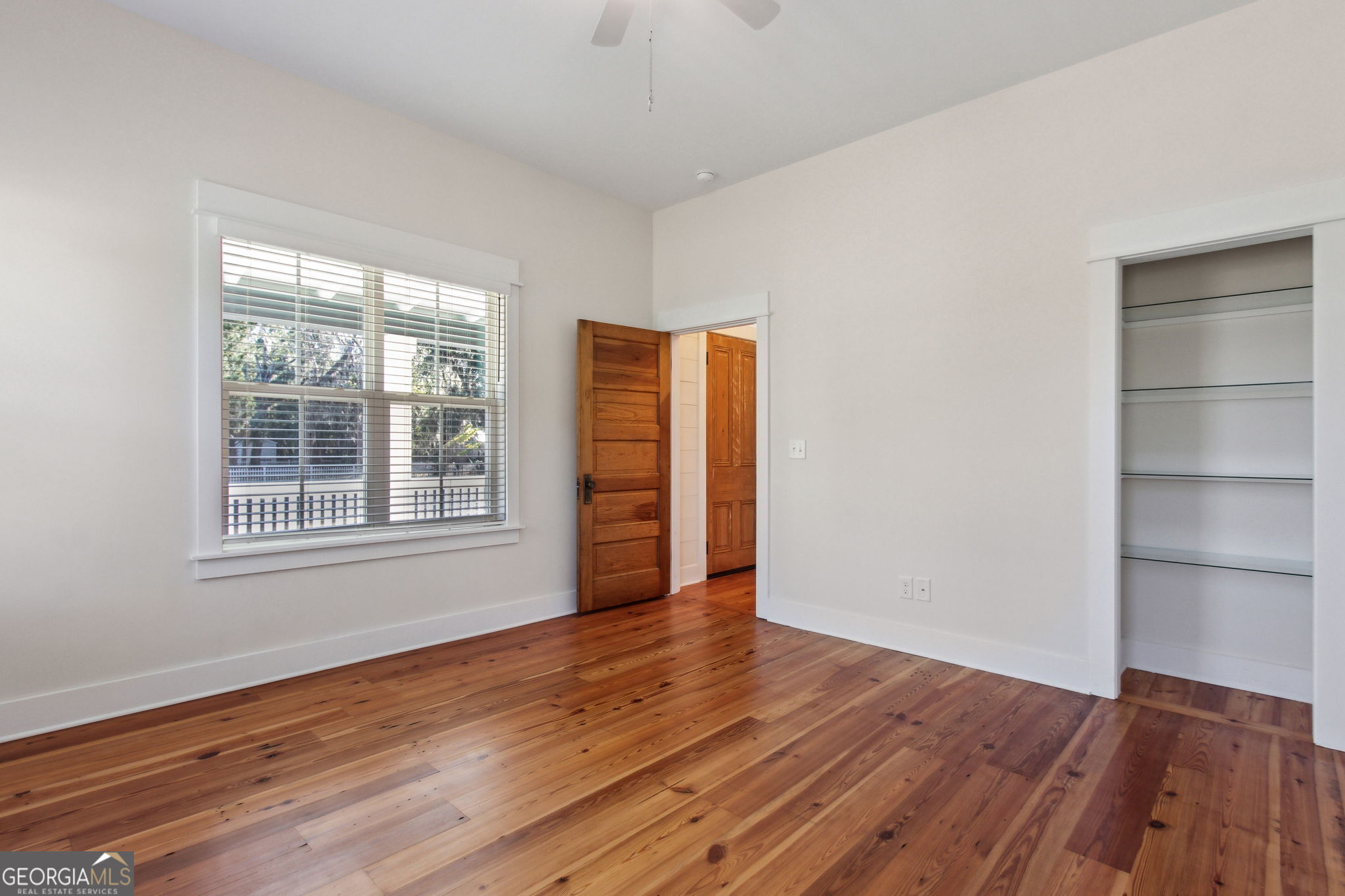 711 Wheeler Street St. Marys, GA 31558 - Photo 23 of 93 an empty room with wooden floor and windows