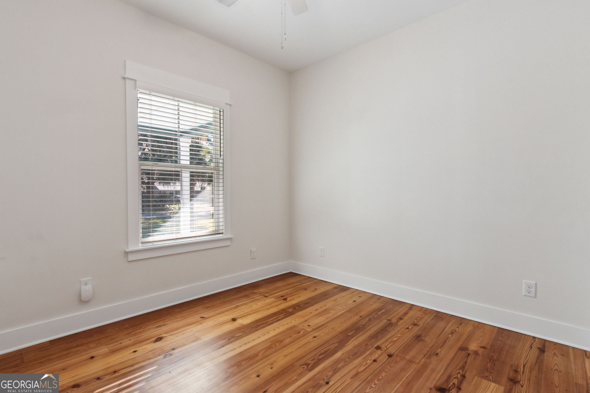 711 Wheeler Street St. Marys, GA 31558 - Photo 27 of 93 an empty room with wooden floor and windows