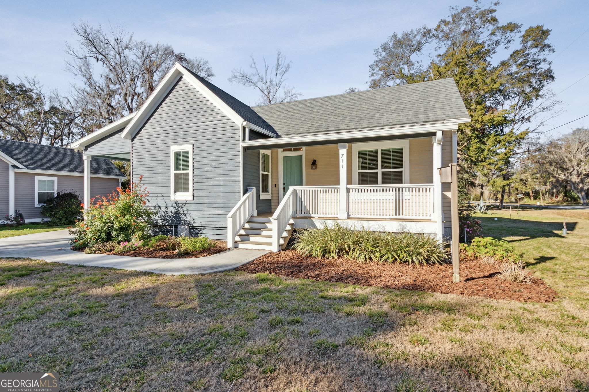 711 Wheeler Street St. Marys, GA 31558 - Photo 3 of 93 a front view of a house with a yard and potted plants