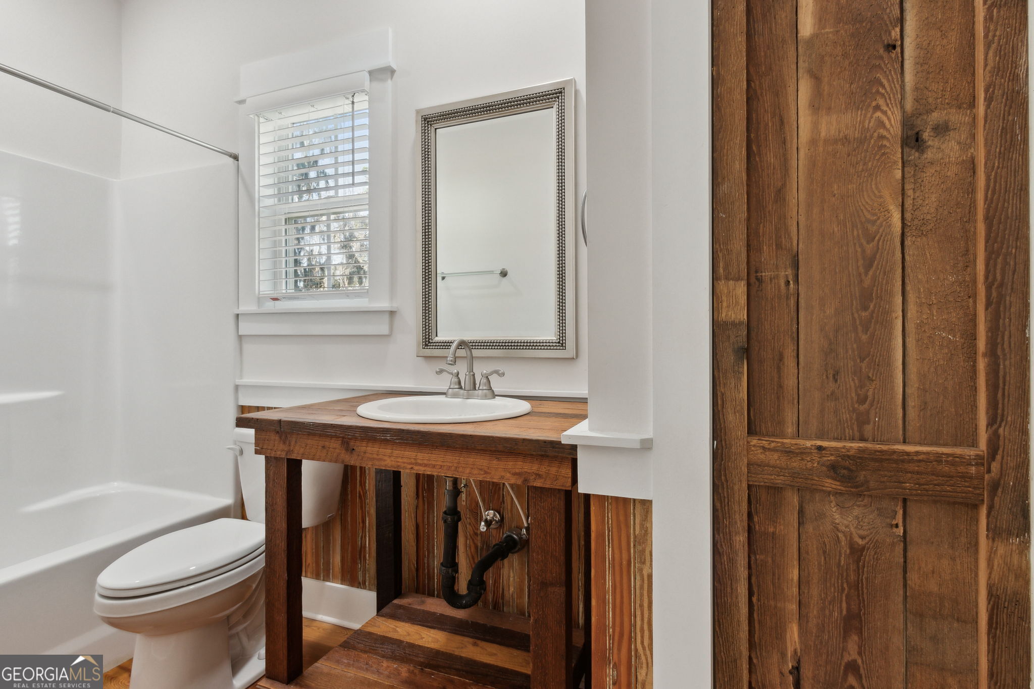 711 Wheeler Street St. Marys, GA 31558 - Photo 31 of 93 a bathroom with a sink a toilet and shower