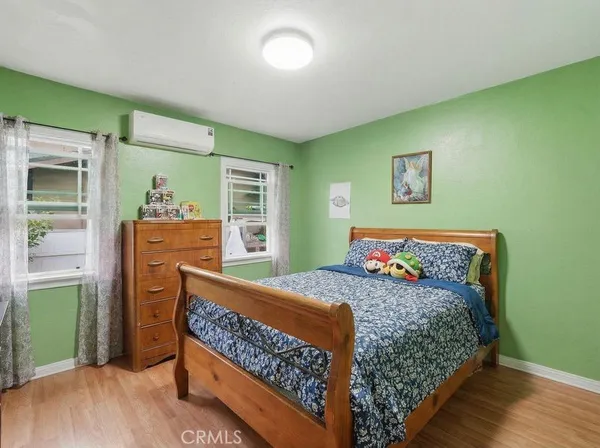 a bedroom with a bed and a dresser