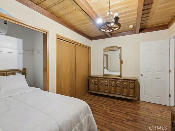 a bedroom with a bed dresser and a window