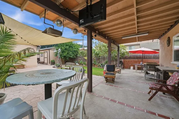 a view of a patio with a table and chairs