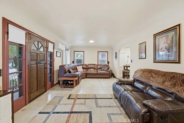 a living room with furniture fireplace and a large window
