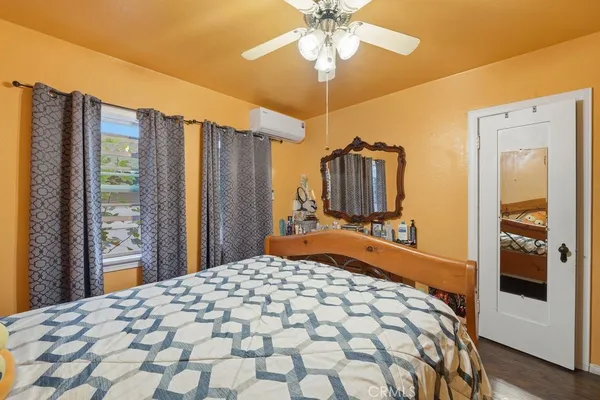 a bedroom with a large bed and a chandelier