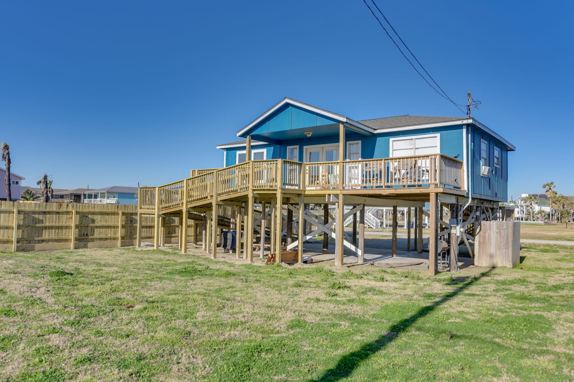 415 Seashell Drive Surfside Beach, TX 77541 - Photo 2 of 10 Back of property featuring a wooden deck and stairway