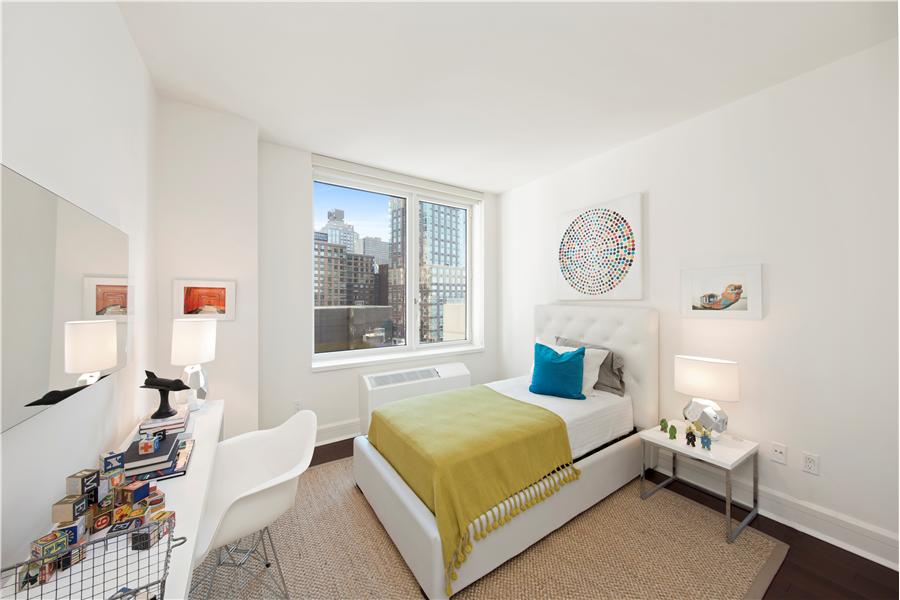 60 Riverside Boulevard, Unit 810 Manhattan, NY 10069 - Photo 7 of 11 a bedroom with a bed and a window