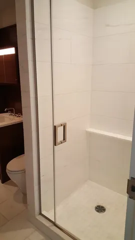 a bathroom with a shower and toilet