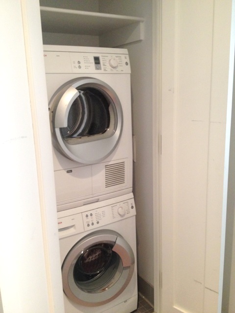 60 Riverside Boulevard, Unit 810 Manhattan, NY 10069 - Photo 10 of 11 a utility room with dryer and washer