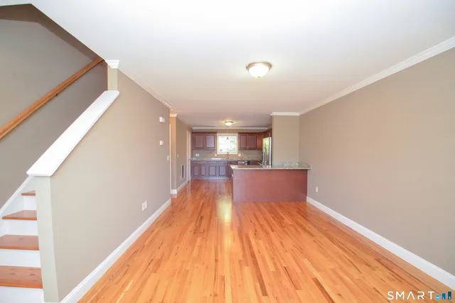 a view of a living room with wooden floor