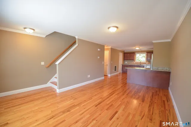 a view of a room with wooden floor and staircase