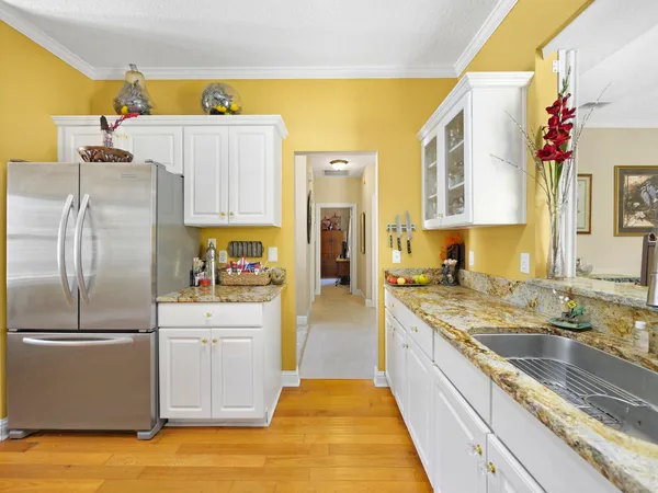 a large kitchen with a refrigerator a sink dishwasher and a stove