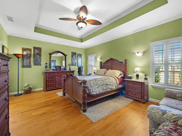 a bedroom with a bed dresser and a window