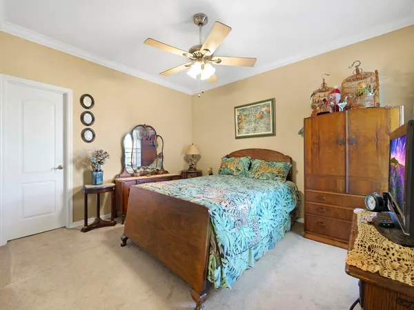 a bedroom with a bed and a chandelier