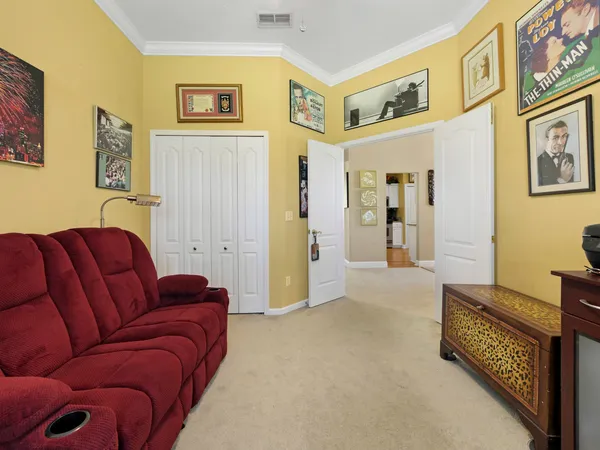 a living room with furniture and a baby crib