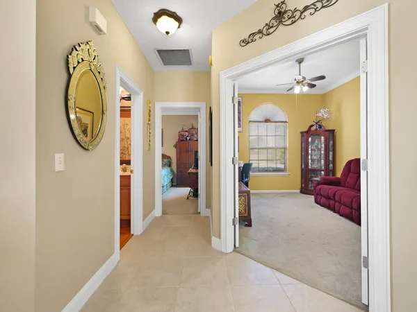 a view of a hallway with a livingroom and a bathroom