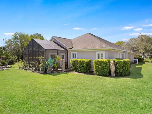 a view of a house with a yard and pathway