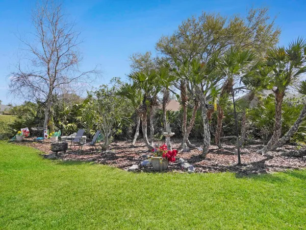 a view of a backyard with sitting area
