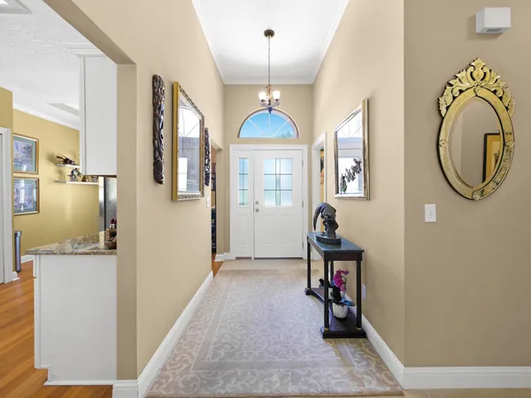 a very nice looking open kitchen with stainless steel appliances granite countertop a stove and a refrigerator