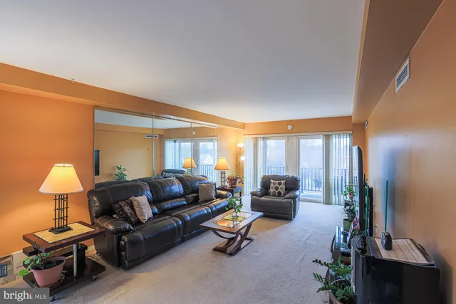 a living room with furniture and a lamp