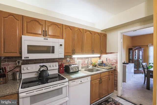 a kitchen with a sink cabinets and appliances