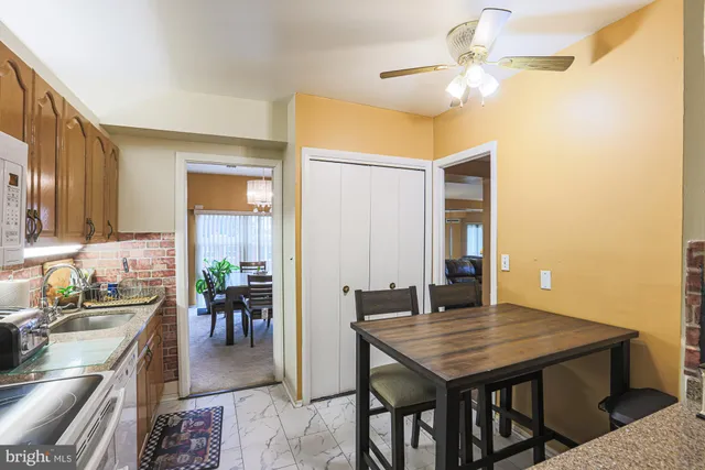 a kitchen with stainless steel appliances granite countertop wooden cabinets a stove top oven a sink and dishwasher