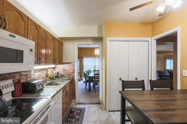 a kitchen with appliances a counter space and a window