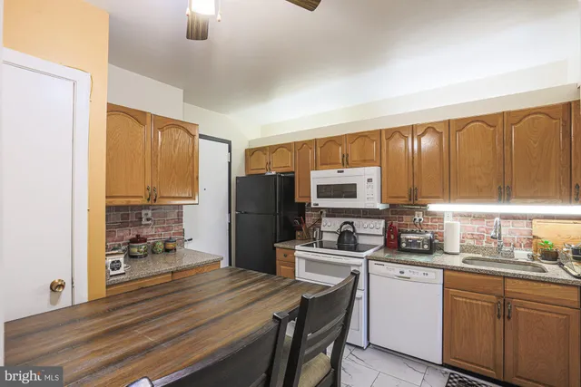 a bedroom with a bed and large windows