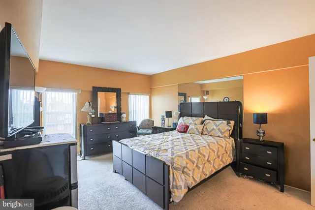 a bedroom with a bed and a television