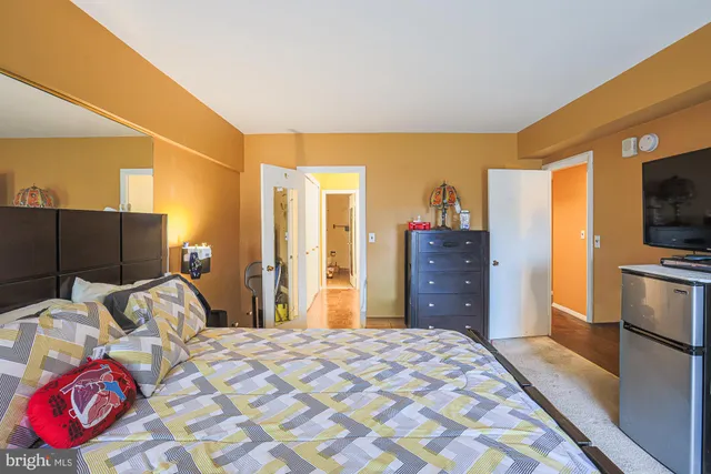 a bedroom with a bed and dresser